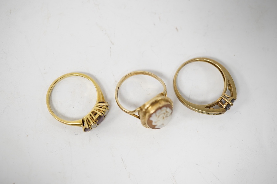 A late 1970's 18ct gold three stone ruby and two stone diamond set ring (one ruby missing), size N/O, gross weight 2.7 grams and two other 9ct gold and gem set rings including cameo shell, gross 5 grams. Condition - poor
